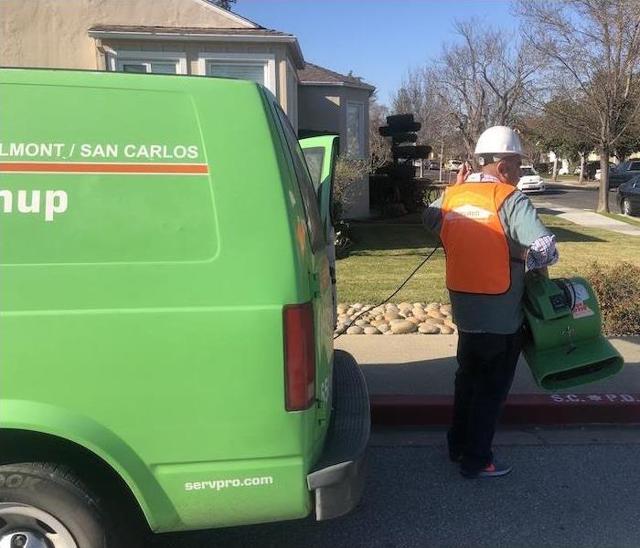 SERVPRO technician getting equipment out of the service vehicle.