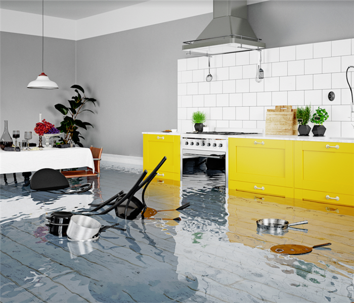 a flooded kitchen and dining room with items floating everywhere