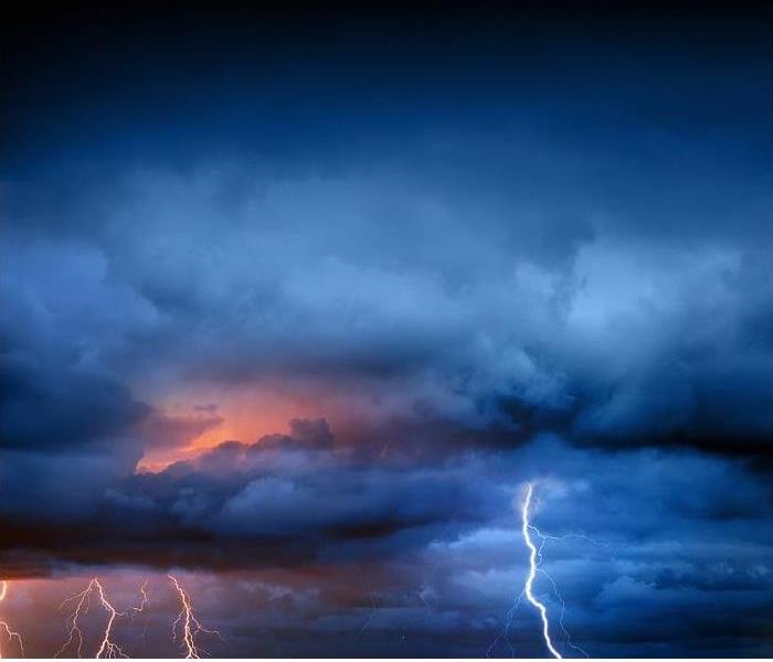 storm clouds against night sky; lightning within clouds